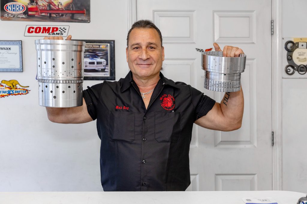 Mad Dog Lou holding 10 speed transmission parts